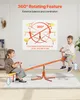 Two children are playing on an orange seesaw in a room with white walls and a light gray rug. Náhľad obrázku produktu