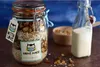 A jar of homemade granola next to a bottle of milk. Anteprima dell’immagine prodotto