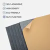 A stack of dark gray acoustic panels with one panel peeling back to reveal its self-adhesive backing. Produktbild-Vorschau