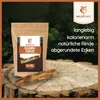 A bag of dog chew sticks and a single chew stick are placed on a tree stump, with a blurred forest background. Anteprima dell’immagine prodotto