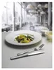 A table setting in a restaurant with a plate of pasta and cutlery. Produktbild-Vorschau