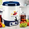 A white and blue electric cooker with a blue lid and a tap, surrounded by fruits like apples and grapes, and a jar of preserved fruit. The cooker has a label with colorful graphics and text. Náhled obrázku produktu