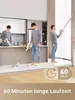 A man is shown using a cordless vacuum cleaner in a modern kitchen and living room setting, demonstrating its versatility. Produktbild-Vorschau