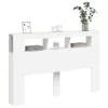 A white headboard with shelves and drawers, decorated with a framed picture, candles, an alarm clock, books, and a vase with greenery. Anteprima dell’immagine prodotto