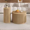 Two round wooden tables are placed on a rug in front of a white sofa. Voir les images du produit