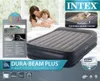 An advertisement for an Intex Dura-Beam Plus air mattress, featuring a woman and child in bed, a close-up of the mattress, and product feature callouts. Náhled obrázku produktu
