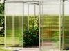 A greenhouse with plants inside, set in a garden. Anteprima dell’immagine prodotto
