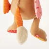 A close-up view of the lower body and legs of a stuffed toy. Anteprima dell’immagine prodotto