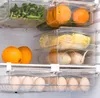 Inside a refrigerator, showing clear plastic storage containers filled with various food items. Náhled obrázku produktu
