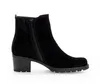 A black suede ankle boot with a side zipper and a block heel, shown from the side against a white background. Produktbild-Vorschau