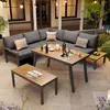 An outdoor patio setting with a sectional sofa, coffee table, and side table, set up for relaxation and entertaining. Podgląd zdjęcia produktu