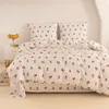 A neatly made bed with floral patterned bedding. Produktbild-Vorschau
