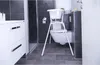 A bathroom scene with a baby bathtub set up over a toilet. Produktbild-Vorschau