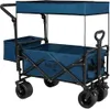 A blue folding wagon with a canopy and side storage bags, shown from a diagonal angle against a white background. Voir les images du produit