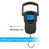 A black portable digital scale with a built-in tape measure is shown against a white background. Produktbild-Vorschau