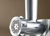 Close-up of a chrome meat grinder attachment. Podgląd zdjęcia produktu