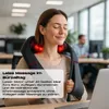 A woman is using a neck and shoulder massager while sitting at a desk in an office environment. Produktbild-Vorschau