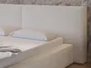 A close-up view of a white bouclé upholstered bed with a headboard and pillows. Produktbild-Vorschau