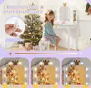 A young girl sits on a stool in front of a white vanity table with a mirror and lights. A decorated Christmas tree is in the background. The image also shows three close-ups of the vanity lights demonstrating different color temperatures. Produktbild-Vorschau