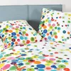 A close-up view of a duvet cover and pillow with a colorful polka dot pattern. Produktbild-Vorschau