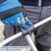 A person wearing blue gloves is adjusting a blue and black bike handle attachment on a silver pole. Anteprima dell’immagine prodotto