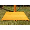 A wooden outdoor shower base on grass with a green hose in the background. Voir les images du produit