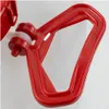 A close-up view of a red plastic handle mechanism with a white roller, attached to a white container. Produktbild-Vorschau