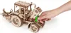 A hand is shown interacting with a wooden model tractor. Náhľad obrázku produktu