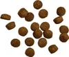 A collection of dog food kibble pieces scattered on a white background. Produktbild-Vorschau