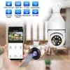 A hand holding a smartphone displaying a smart camera app, with a smart camera and its features illustrated in the background. Náhľad obrázku produktu