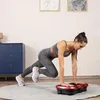 A woman is exercising on a vibration plate in a room. Náhled obrázku produktu