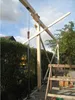 A construction scene with wooden beams and a support pole. Produktbild-Vorschau
