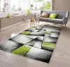 A modern living room with a gray sofa, a small side table, and a geometric rug.