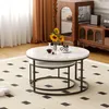 A nesting coffee table set with a marble top and black metal legs, placed on a cream rug with a black diamond pattern. Sunflowers in a vase and a decanter with wine are on the table. Voir les images du produit
