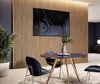 A modern dining area with a slatted wood wall, a large abstract artwork, a round dining table with chairs, and a potted plant. Náhled obrázku produktu
