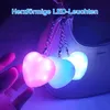 A hand holding three heart-shaped LED lights attached to a handbag. Produktbild-Vorschau