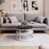 A living room scene with a sofa, coffee table, and artwork. Produktbild-Vorschau