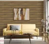A living room scene with a yellow sofa, coffee table, and artwork on a wood-paneled wall. Produktbild-Vorschau