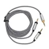 A black and white braided audio cable with two 3.5mm jack connectors on one end and one on the other, laid out on a white background. Náhled obrázku produktu