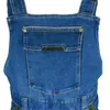 A close-up view of the bib pocket of blue denim overalls. Náhled obrázku produktu