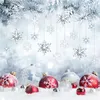 Christmas ornaments and snowflakes are arranged in the snow, with frosted pine branches overhead. Produktbild-Vorschau