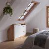 A bedroom with a slanted ceiling, featuring a storage unit under a skylight and a bed with a blanket. Náhled obrázku produktu