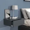 A modern bedroom setting with a wall-mounted nightstand next to a bed. Produktbild-Vorschau