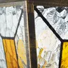 A close-up view of a lantern's stained glass panels and metal frame. Anteprima dell’immagine prodotto