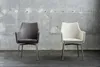 Two chairs are placed in front of a concrete wall. Produktbild-Vorschau