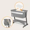 A baby crib with a mattress being placed into it, and a diagram showing height adjustment options. Náhľad obrázku produktu