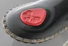 Close-up of the sole of a shoe with a red insert. Produktbild-Vorschau