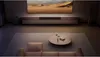 A living room scene with a TV, soundbar, and furniture. Náhled obrázku produktu