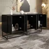 A black sideboard with its doors open, displaying decorative items inside, in a modern room setting with marble-like flooring and abstract art on the wall. Voir les images du produit