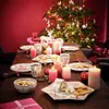 A festive Christmas table setting with a decorated tree in the background. Produktbild-Vorschau